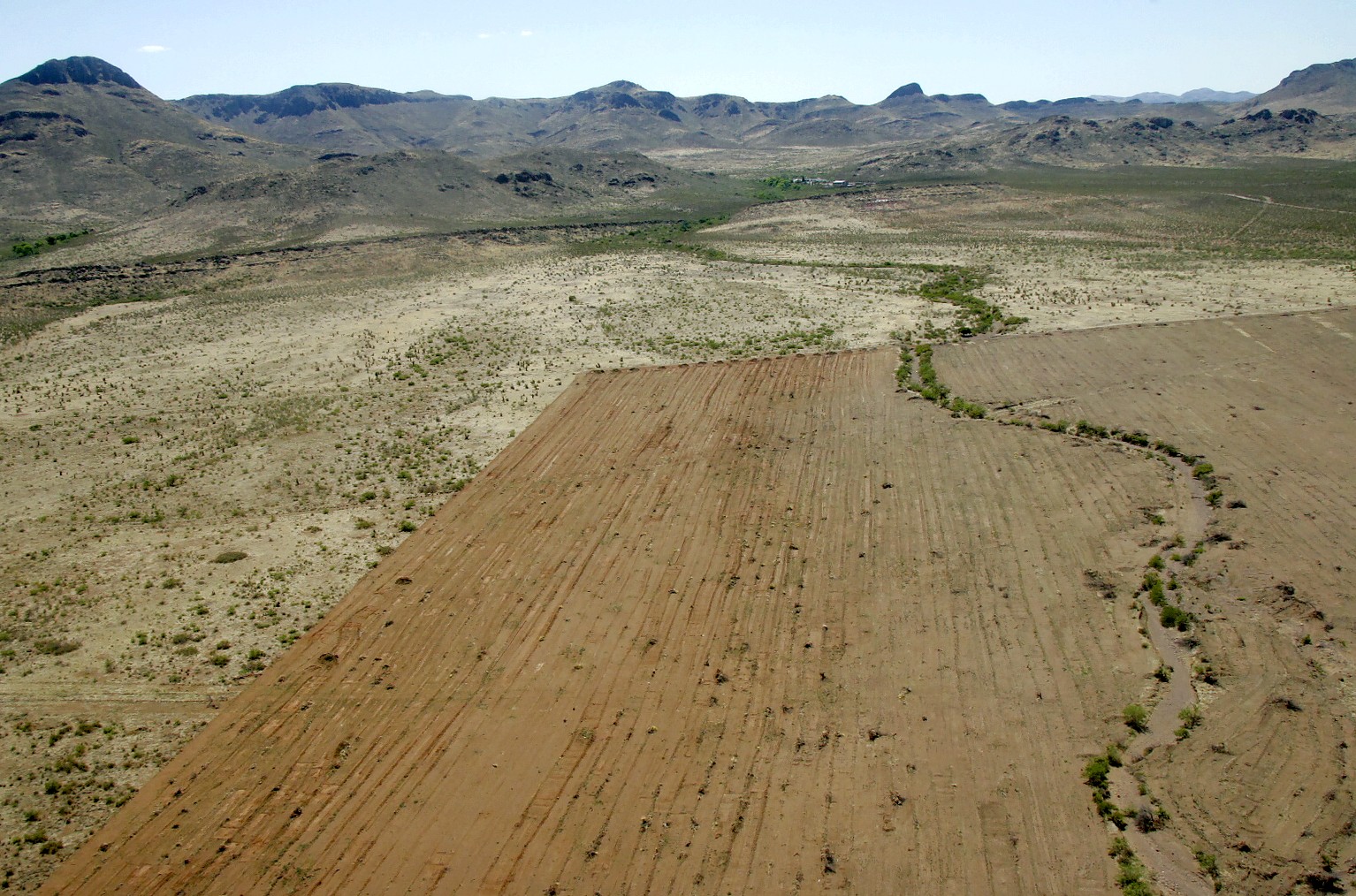 This aerial image shows the striking contrast between cleared crop fields and healthy grassland habitat. Photo by Ken Stinnet.