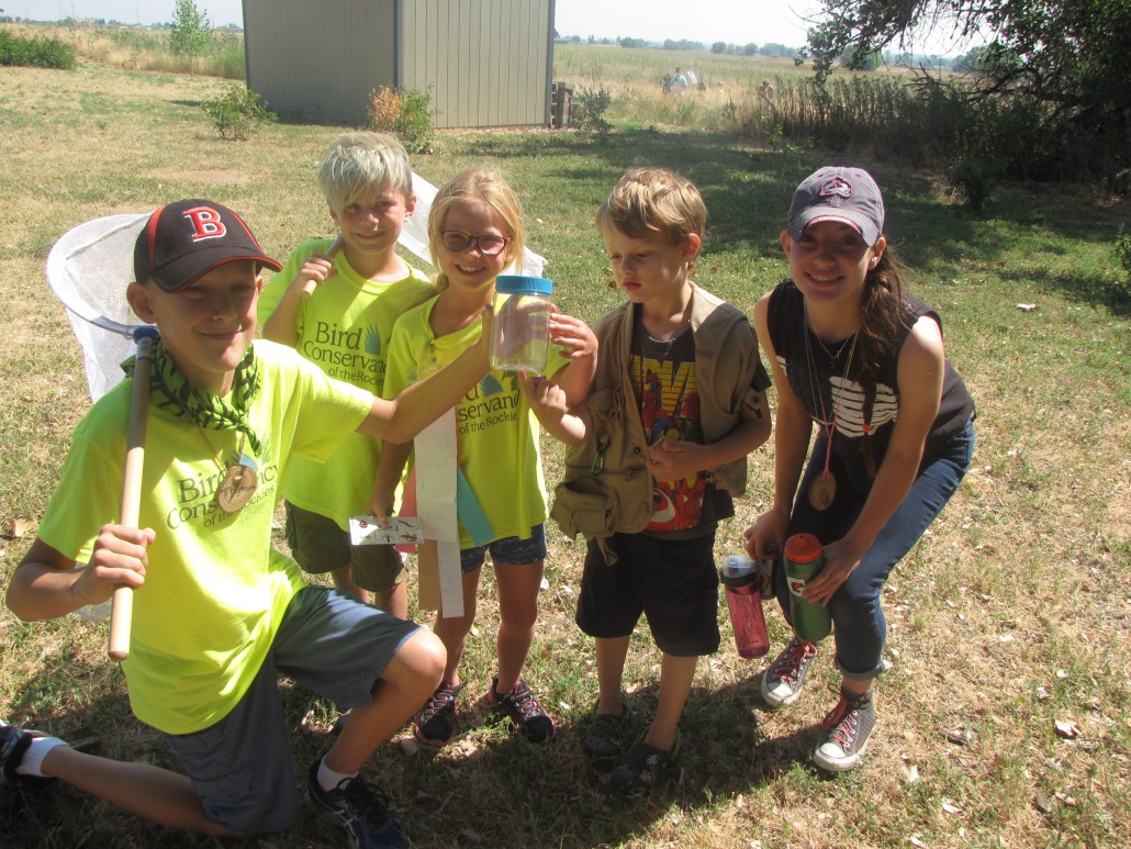 Nature Investigators Day Campers showing off their bugs with two LIT’s.