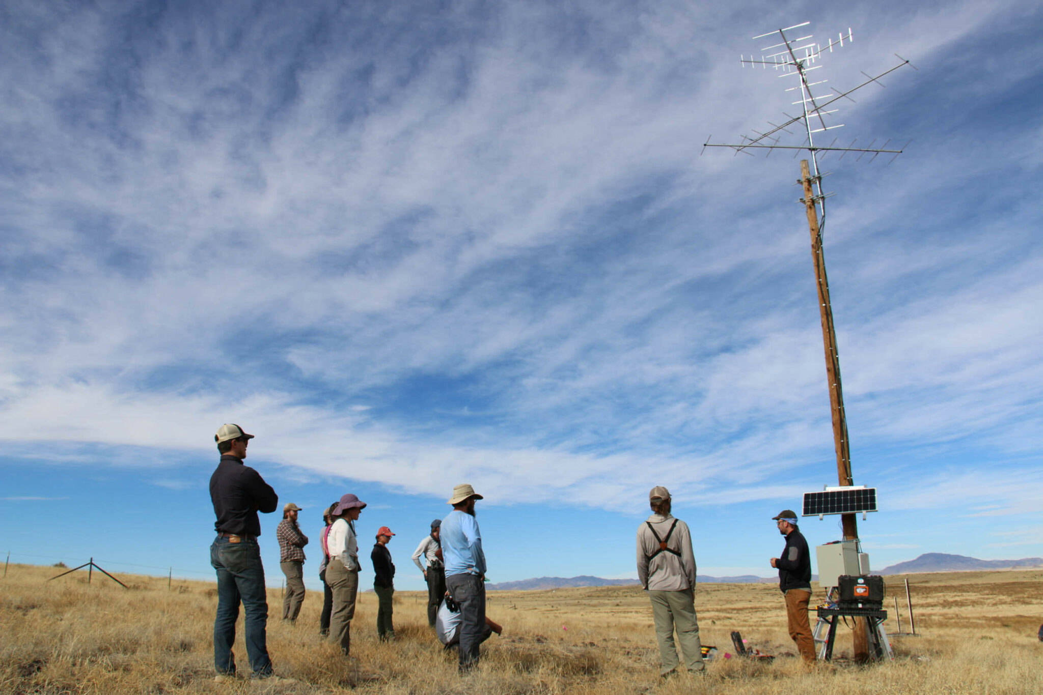 The United States field crew and students from the Universidad Autónoma de Chihuahua learn about a Motus station that Bird Conservancy of the Rockies staff installed on the Dixon Water Foundation’s Mimms Unit Ranch in Marfa, Texas. Photo by Matt Webb.